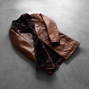 Styled Fit Perspective of Men's Cinnamon Distressed Leather Fur Leren Jas voor Heren on Model - Natural Daylight Drape